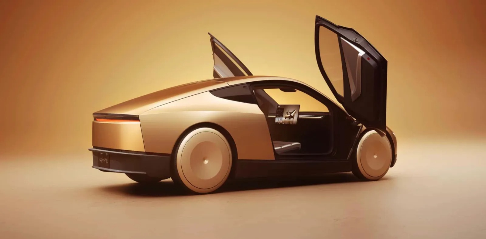 A sleek gold two-seat car with its doors swung open upward, on a warm studio background.